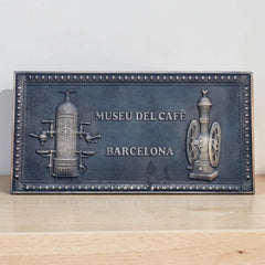 Bronze plaque for Museu del Cafeè Barcelona on a wooden surface