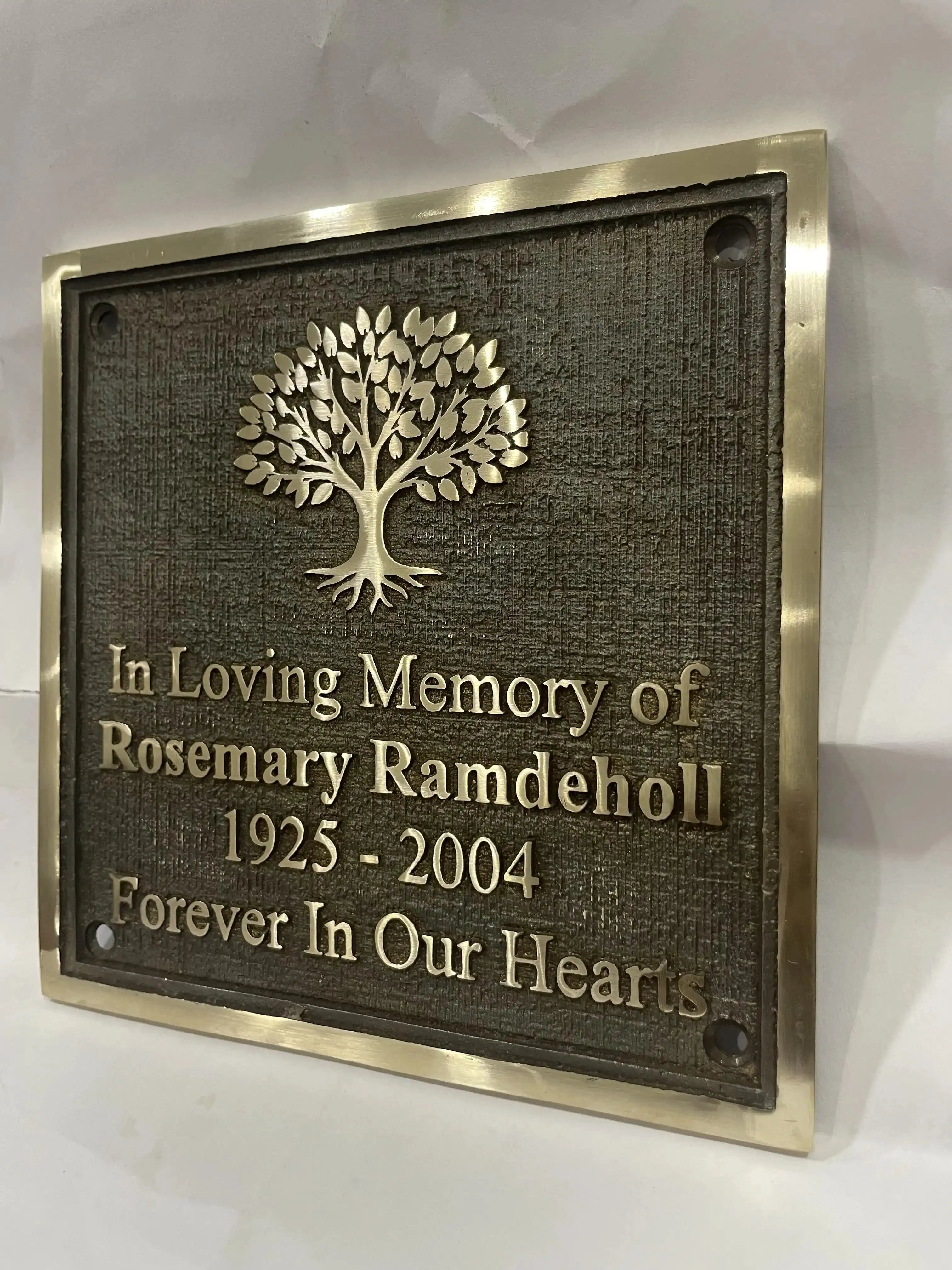 Bronze Memorial plaque with tree design and text on a white background