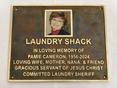 Memorial plaque for Pamie Cameron with a photo of a woman on a white background