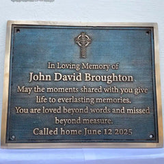 Memorial plaque for John David Broughton with a Celtic cross design on a blue background.
