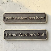 Two customizable nameplates on a textured surface
