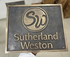 bronze plaque with 'Sutherland Weston' branding on a neutral background