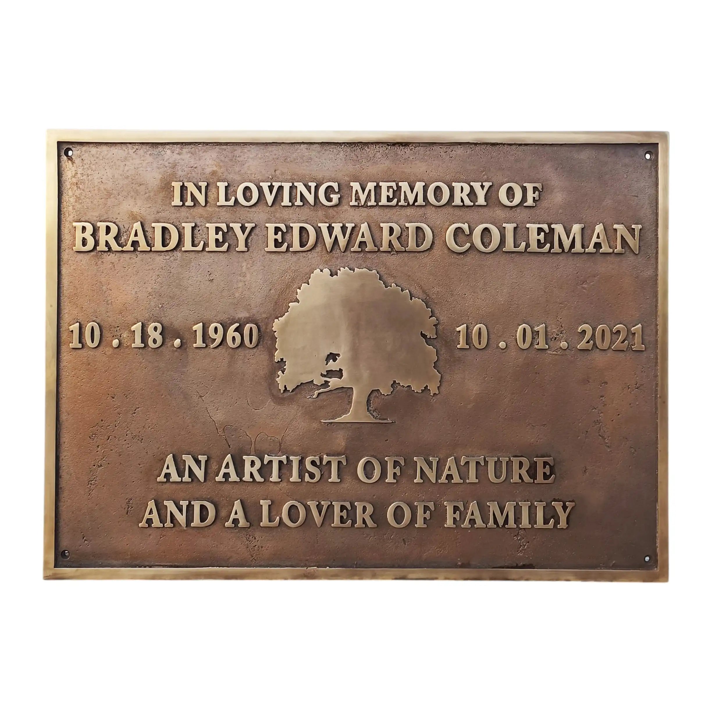 Bronze plaque with engraved text and tree design on a white background
Memorial plaques