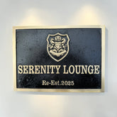 Serenity Lounge sign with crest on a wall