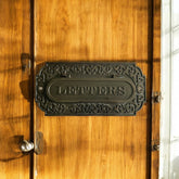 Decorative letter box on a wooden door
mail slot for door