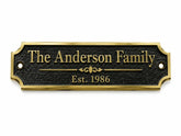 A personalized black metal house plaque with a gold border and gold lettering that reads 'The Anderson Family' and 'Est. 1986', shown on a plain white background.