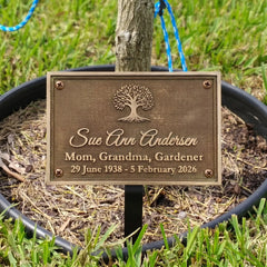 Bronze plaque with engraved text in a garden setting