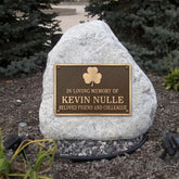 Memorial bronze plaque with a stone honoring Kevin Nulle in a garden setting.