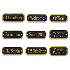 Nine personalized house nameplate options shown on a plain white background, each with a black textured face, gold border, and gold lettering for phrases such as Johnson Family, Welcome, Office, Reception, Suite 203, Memorial Garden, The Smiths, 125 Oak Street, and Private Property.