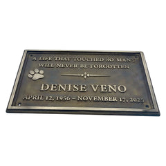 Memorial plaque for Denise Veno with text and paw print on a white background