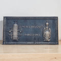 Bronze plaque for Museu del Cafeè Barcelona on a wooden surface