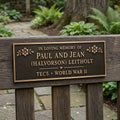 Memorial plaque for Paul and Jean (Halvorson) Leitholt in a garden setting.