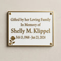 Memorial plaque for Shelly M. Klipple on a beige wall