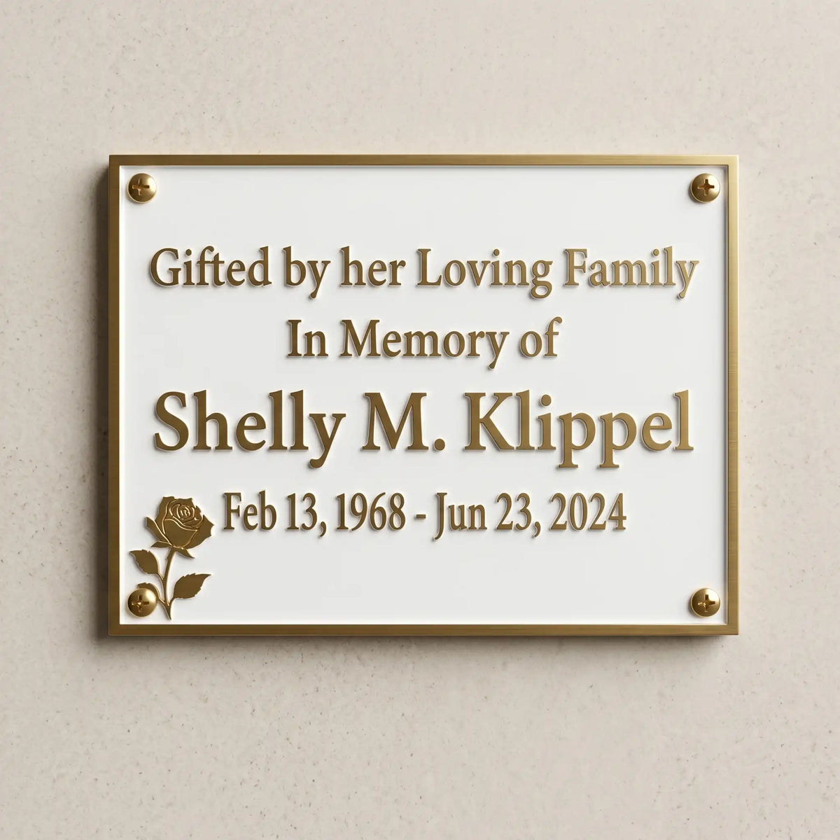 Memorial plaque for Shelly M. Klipple on a beige wall