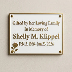 Memorial plaque for Shelly M. Klipple on a beige wall