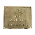 Brass plaque with 'MAISON LAVAILLE' and a decorative emblem on a white background