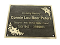 Memorial plaque with engraved text and floral designs on a white background
