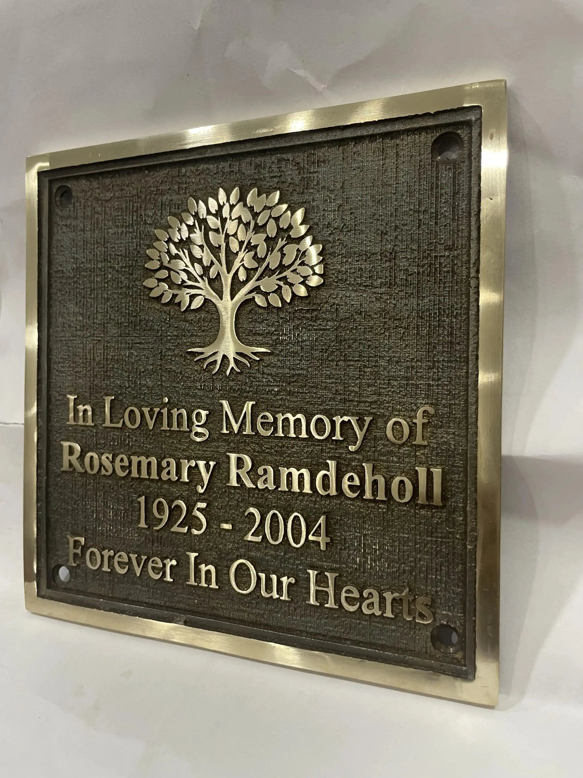Bronze Memorial plaque with tree design and text on a white background