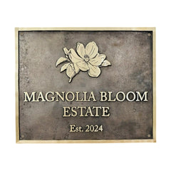 Address sign with 'Magnolia Bloom Estate' and a floral design on a textured background.