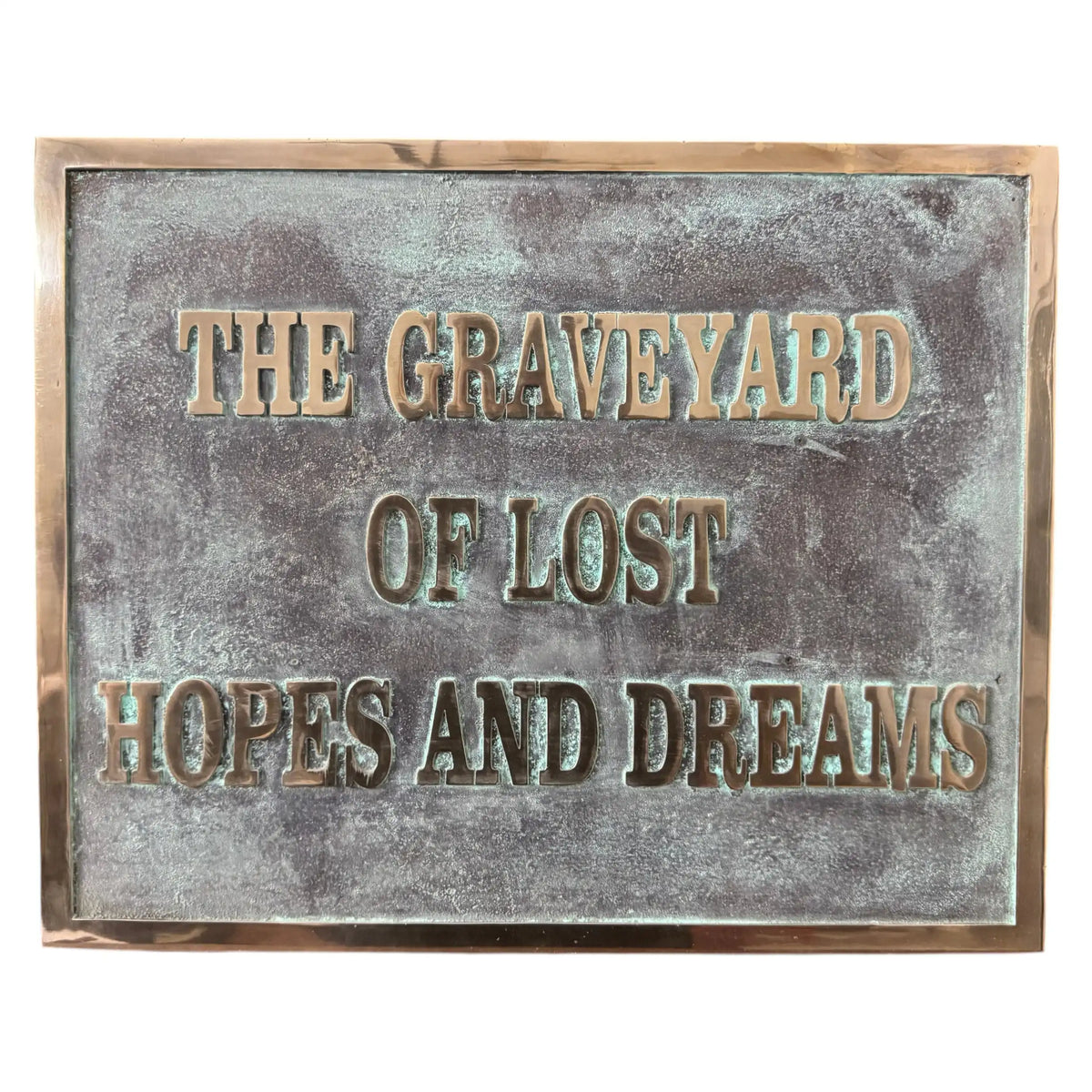Bronze plaques with text 'The Graveyard of Lost Hopes and Dreams' on a textured surface.