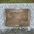Bronze plaque on a stone wall with engraved text in memory of Terry G Salas.