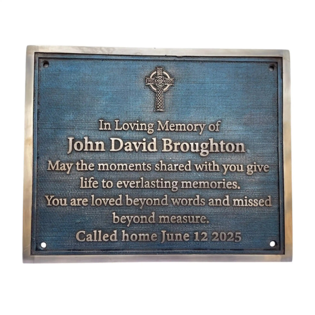 Memorial plaque with Celtic cross design on a blue background