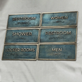 Set of restroom signs with Braille text on a white background - Bronze personalized office door plaque