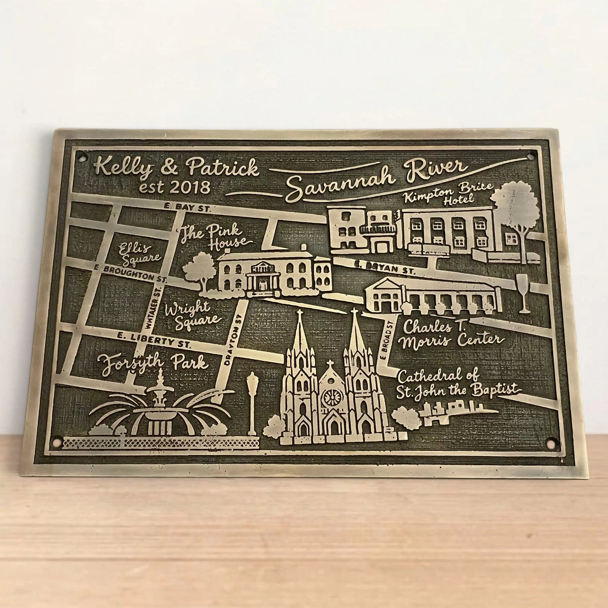 Personalized map plaque of Savannah, Georgia on a wooden surface with a white background