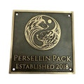 Bronze plaque with wolf design and 'Persellin Pack Established 2018' text on a white background