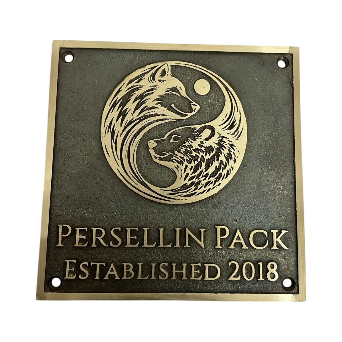 Bronze plaque with wolf design and 'Persellin Pack Established 2018' text on a white background