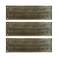 Three bronze plaques with engraved text on a white background