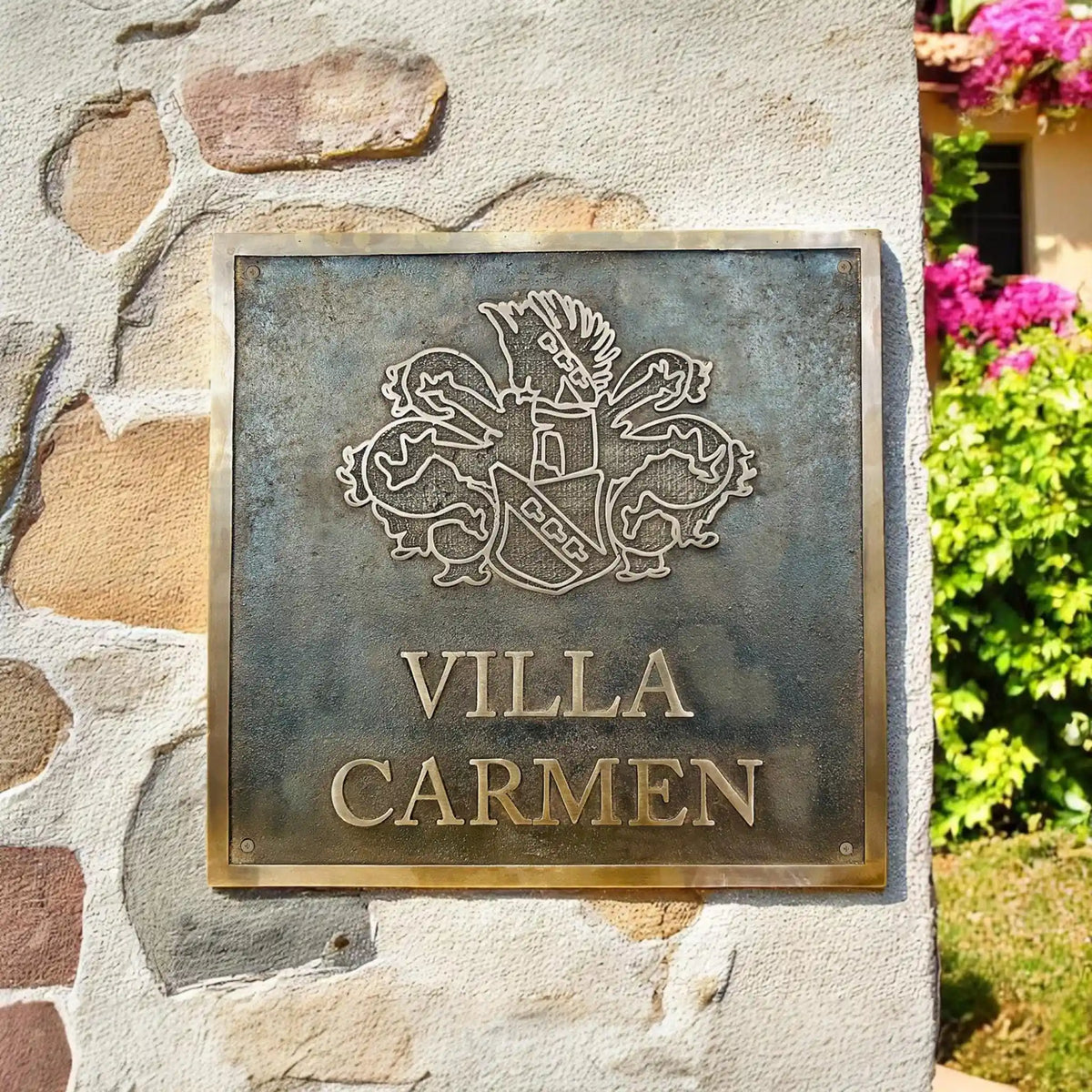 Bronze plaque with 'Villa Carmen' on a stone wall