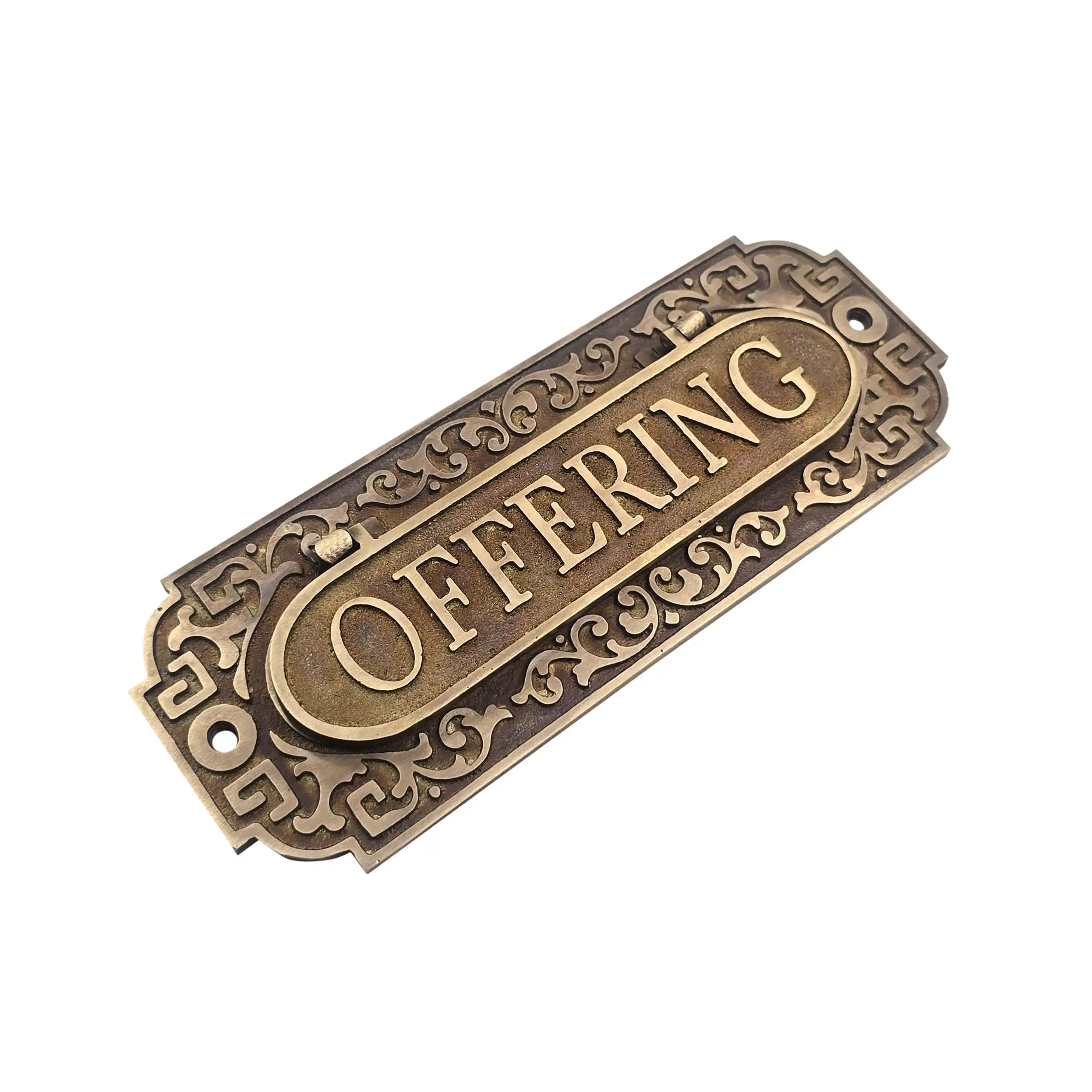 An antique bronze metal  sign with ornate scrollwork borders and a central oval plaque, shown on a plain white background.