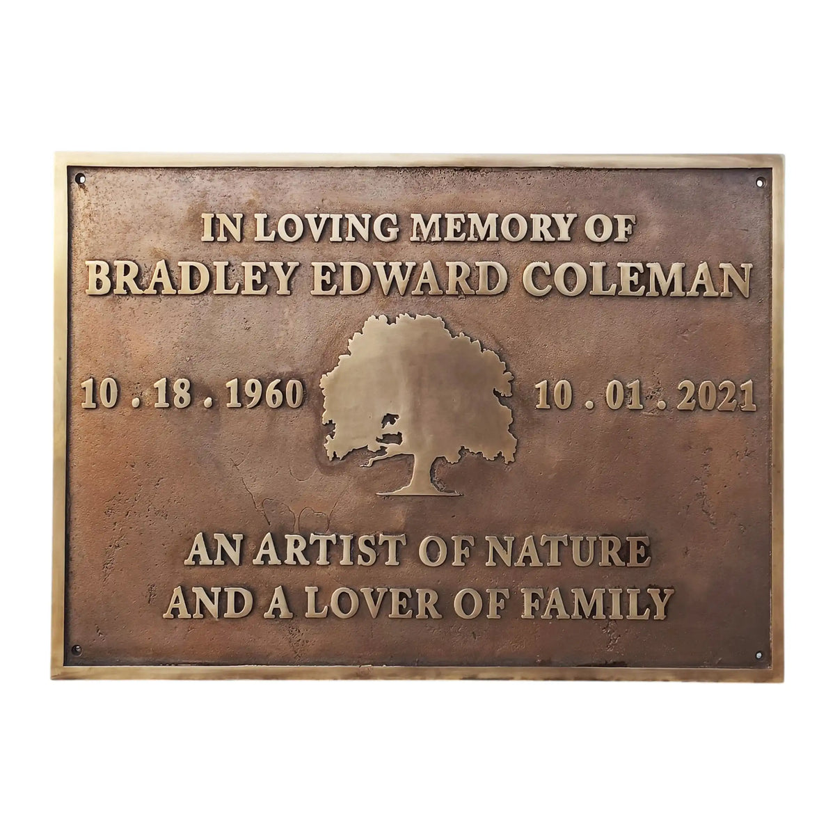 Bronze plaque with engraved text and tree design on a white background
Memorial plaques