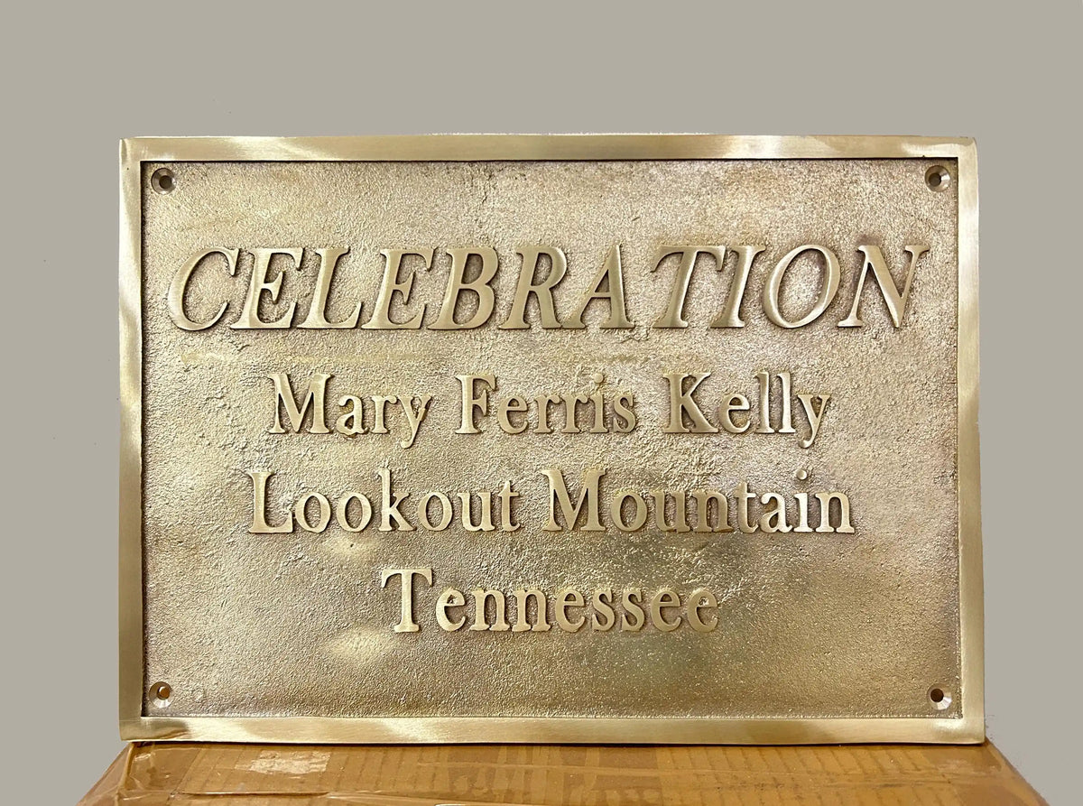 Brass plaque with engraved text on a wooden surface