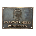 Metallic plaque with a crest and text on a white background