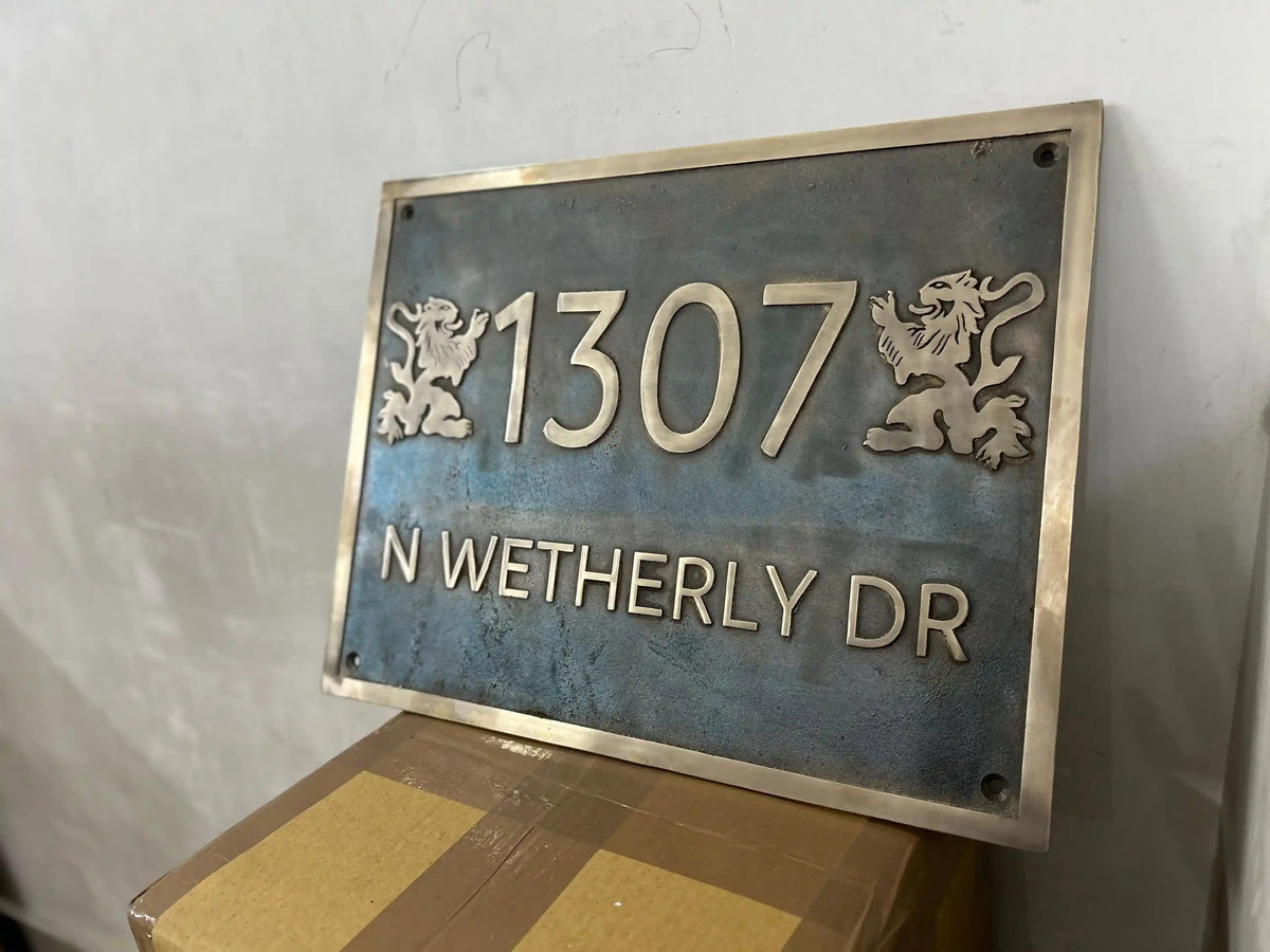 Metal address sign with number '1307' and text 'N WETHERLY DR' on a textured wall.