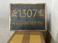 Decorative house number sign with '1307 N WETHERLY DR' on a metallic background.
