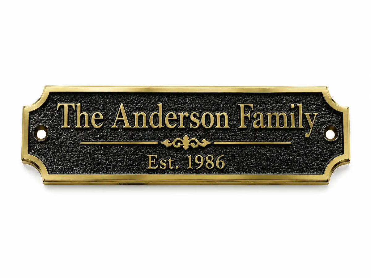 A personalized black metal house plaque with a gold border and gold lettering that reads 'The Anderson Family' and 'Est. 1986', shown on a plain white background.