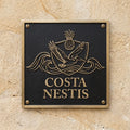 Address sign with 'Costa Nestis' on a textured wall