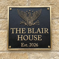 Bronze Plaque with eagle design and 'The Blair House Est. 2026' text on a stone wall.