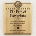 Memorial plaque for dogs with engraved text and a dog's face, on a light background.