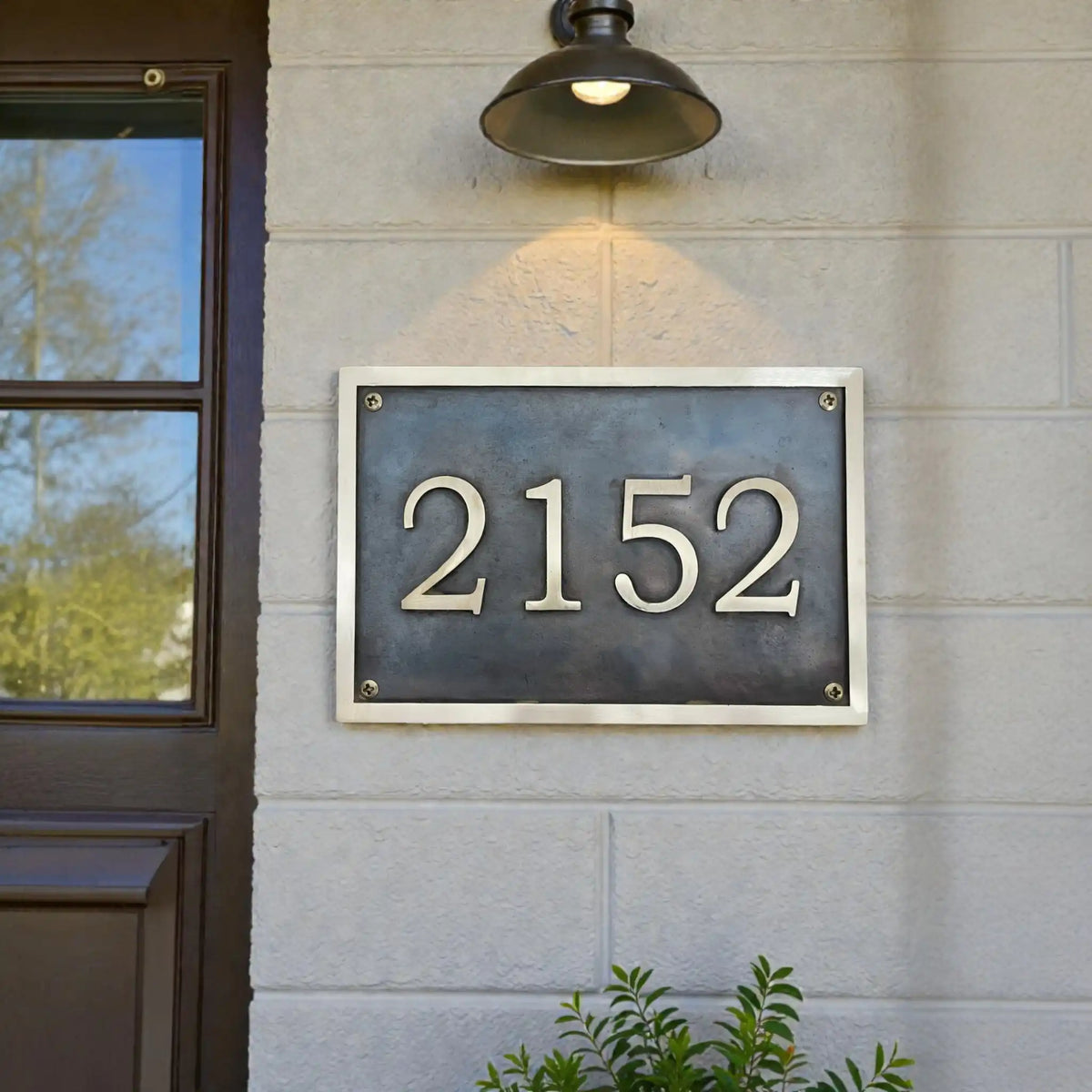 Bronze address plaque - House number plaque mounted on a building exterior.