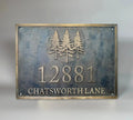 Bronze house number plaque with dark oxidized background