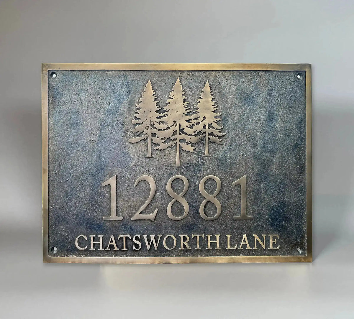 Bronze house number plaque with dark oxidized background