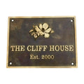 Bronze metal sign with floral design and text 'The Cliff House Est. 2000' on a white background