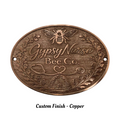 Bronze plaque with 'Gypsy Nurse Bee Co' text and bee design on a white background