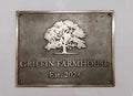 Bronze plaque with an oak tree design and 'Griffin Farmhouse Est. 2024' text on a gray background