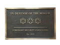 Bronze Plaque with 'In Defense of the Maker' and 'Foresight Security Consulting' text on a white background