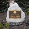 Memorial bronze plaque with a stone honoring Kevin Nulle in a garden setting.